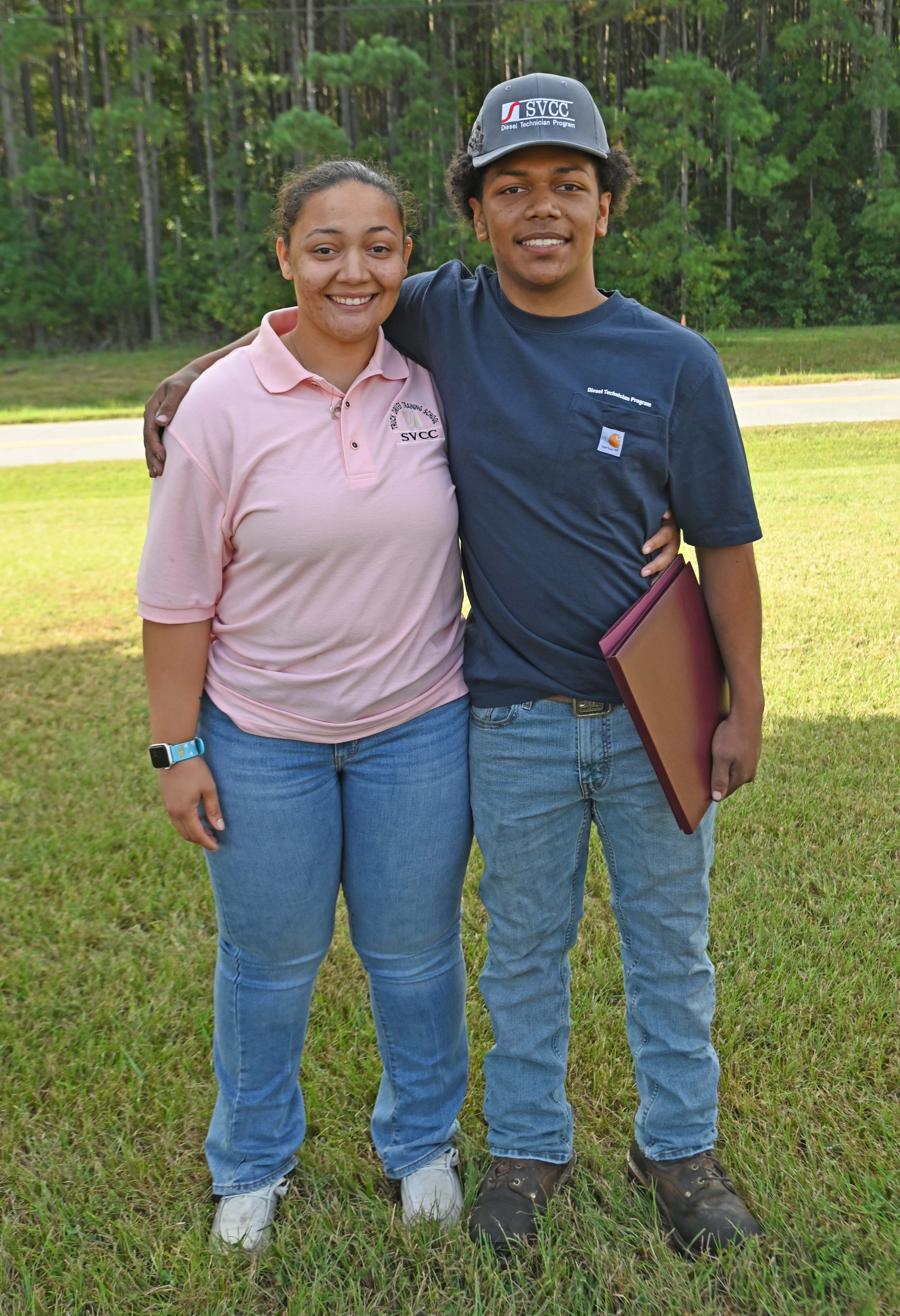 Kayla and Dakota standing outdoors wearing SVCC apparel