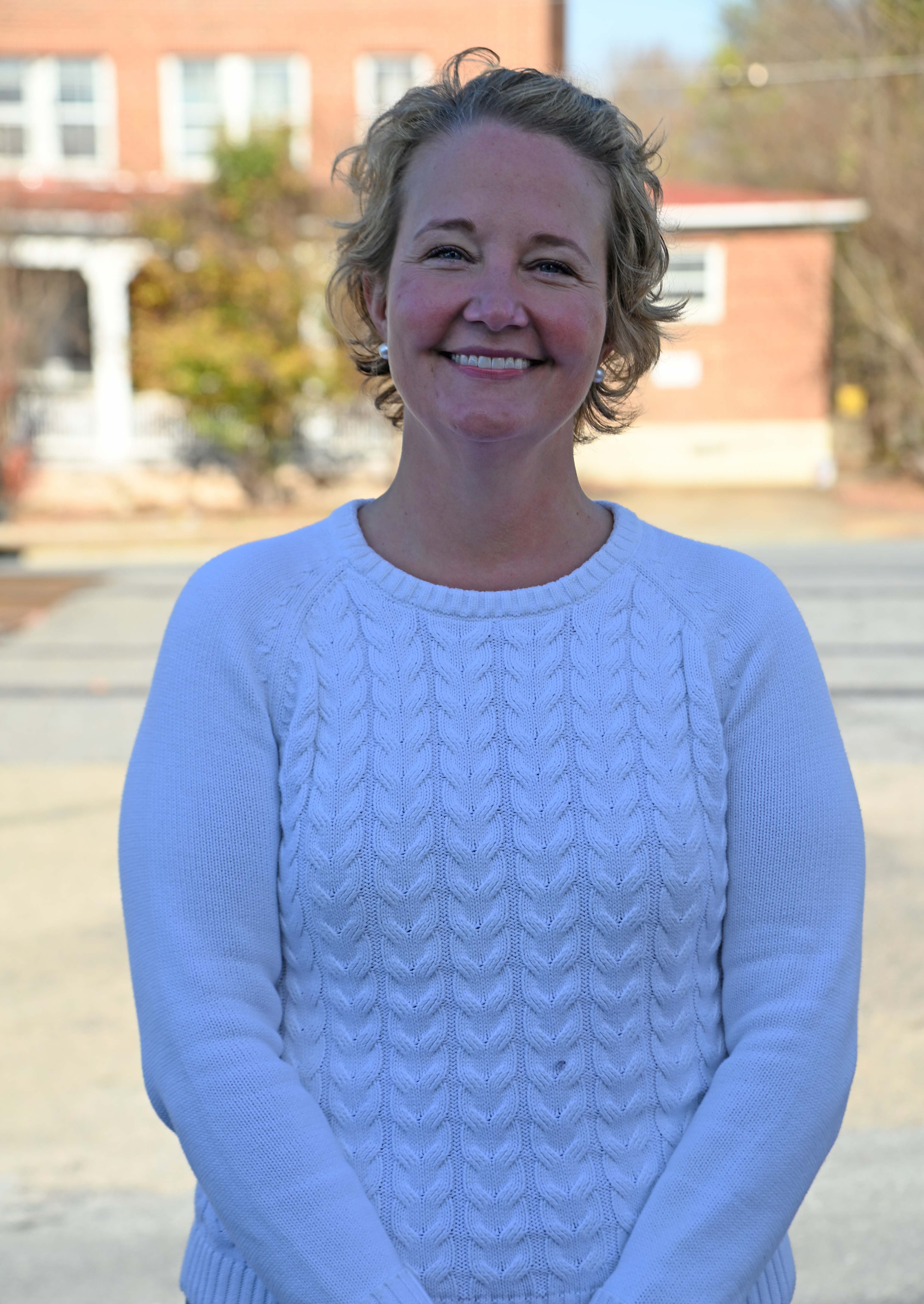 Maggie Wilkerson posing standing outside in front of a building