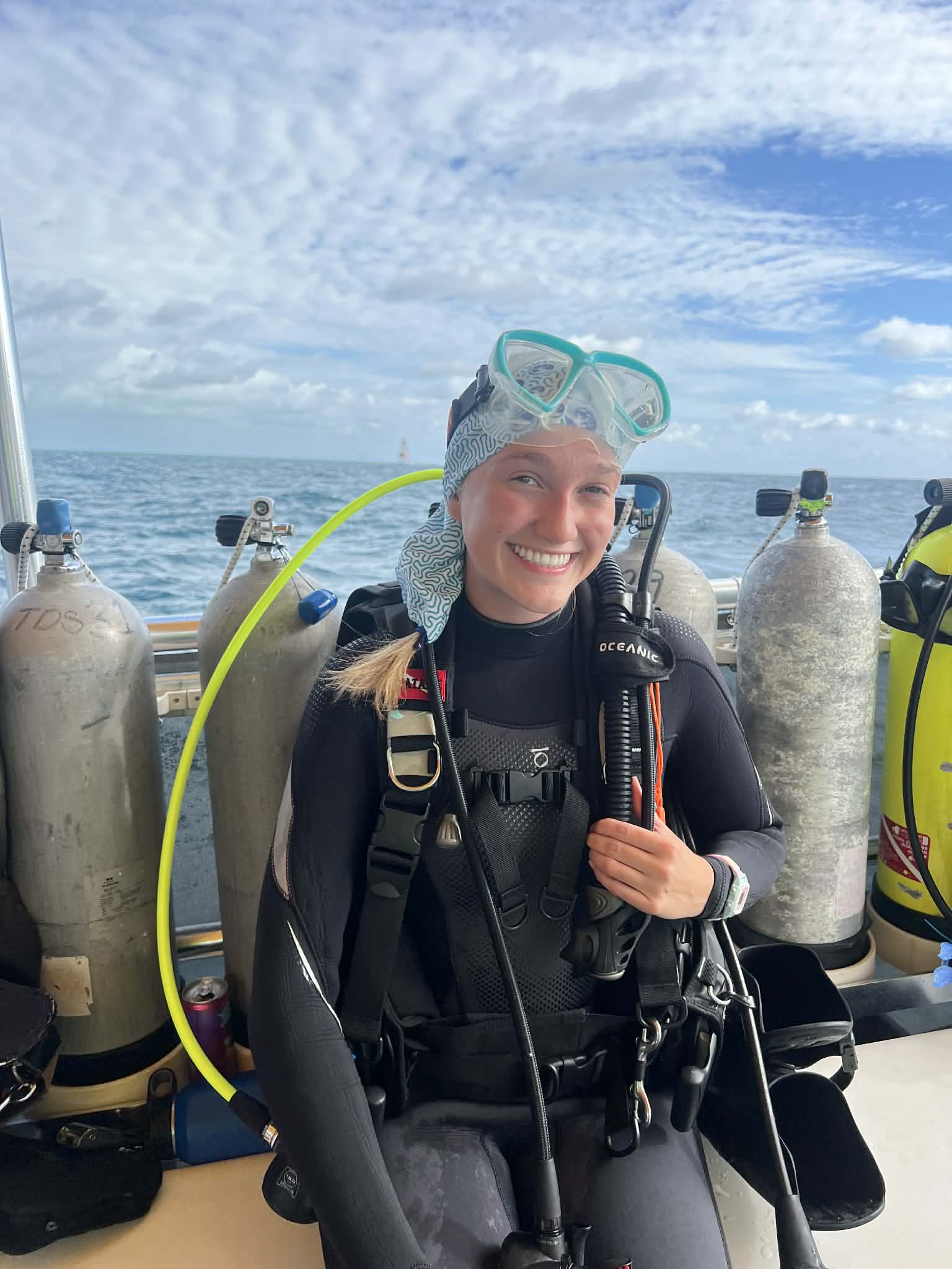woman in scuba gear on a boat