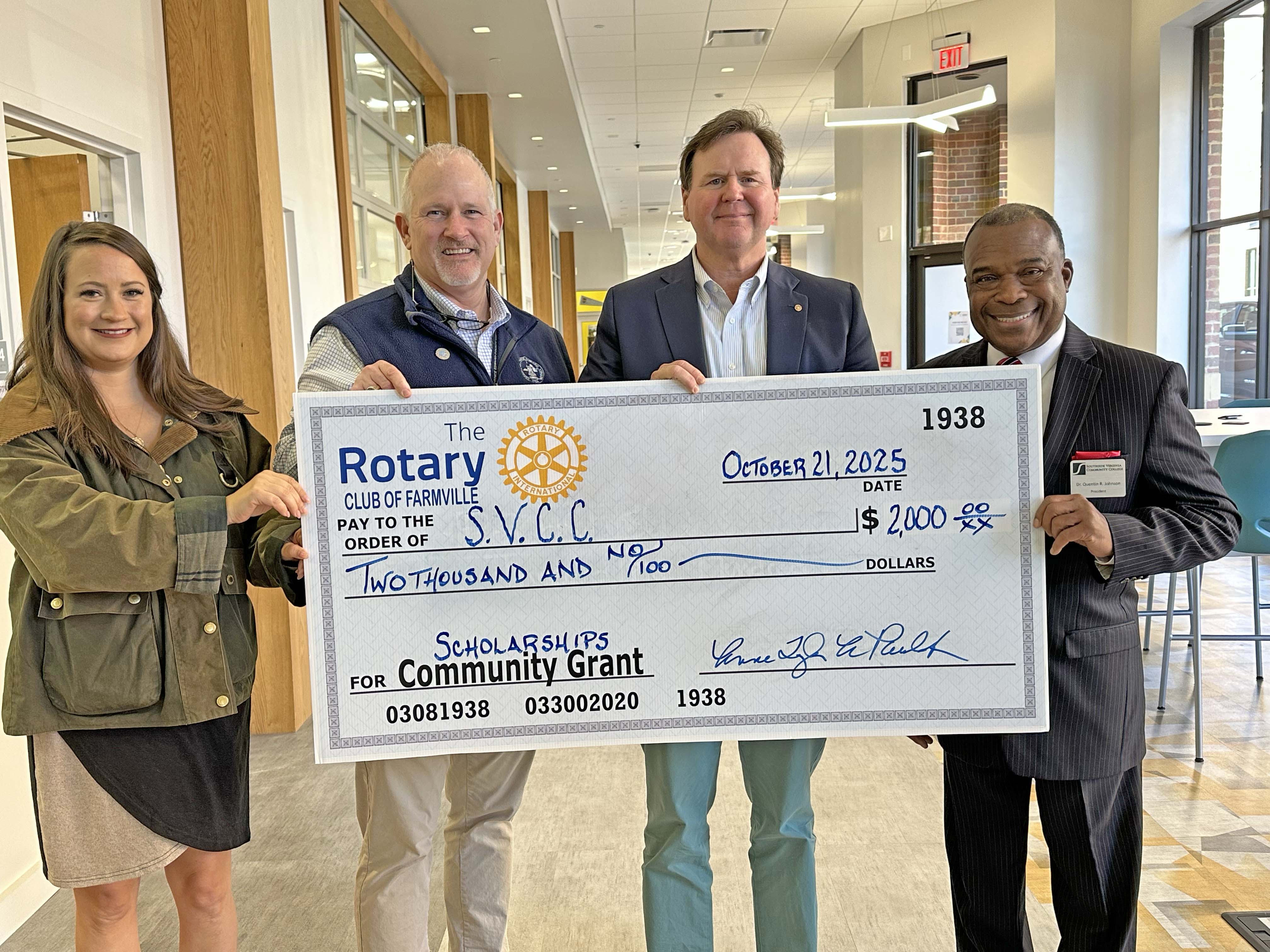 Farmville Rotary representatives and SVCC President Johnson holding a large donation check